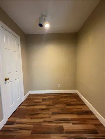 a view of room with wooden floor