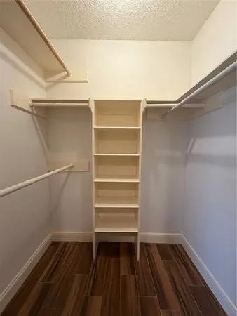 a view of walk in closet with empty racks