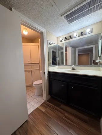 a spacious bathroom with a toilet sink and mirror