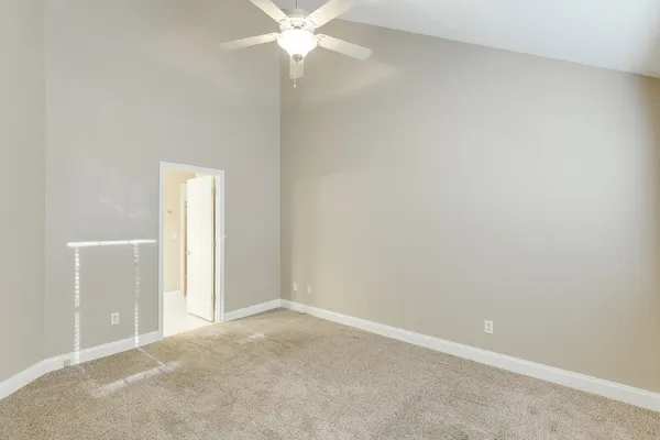 an empty room with a fan and a fan