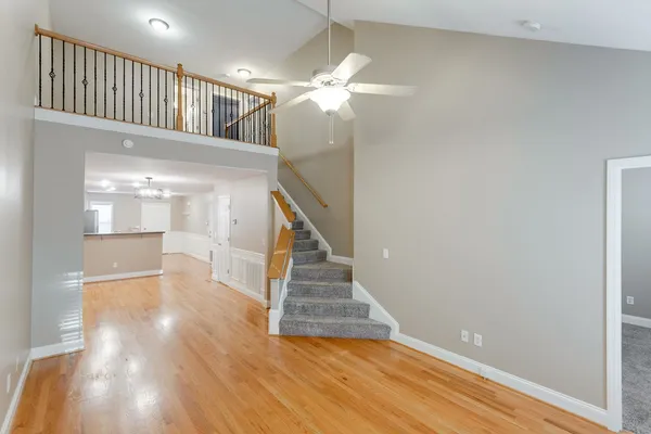 a view of entryway and hall with wooden floor