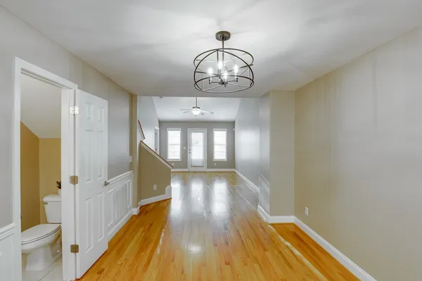 a view of empty room with wooden floor