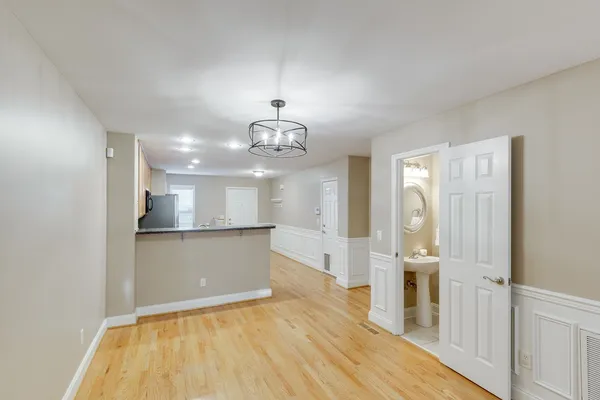 a view of a kitchen with a sink and wooden floor