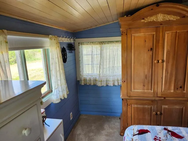 a white house that has a tree in front of it