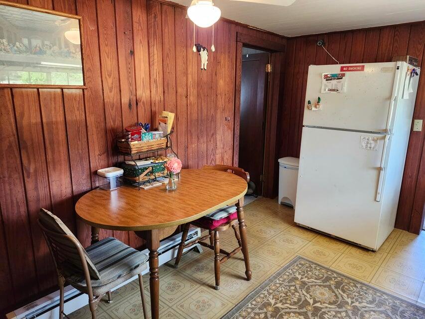 258 Briar Road DeFuniak Springs, FL 32433 - Photo 8 of 25 a dining room with furniture and a refrigerator