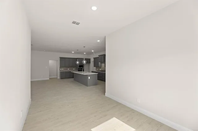 a view of a kitchen with a sink and cabinets