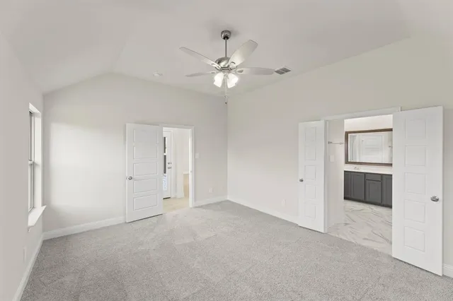 a view of an empty room with a ceiling fan