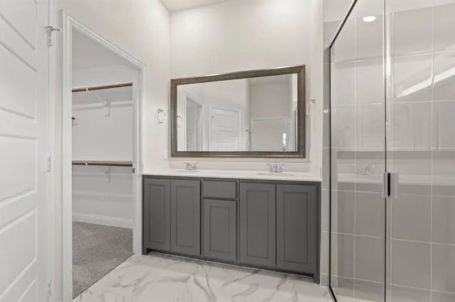 a bathroom with a mirror and a shower