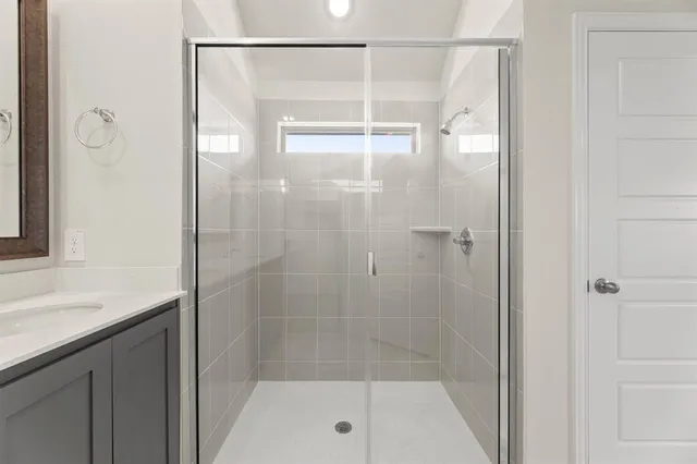 a bathroom with a shower and a sink
