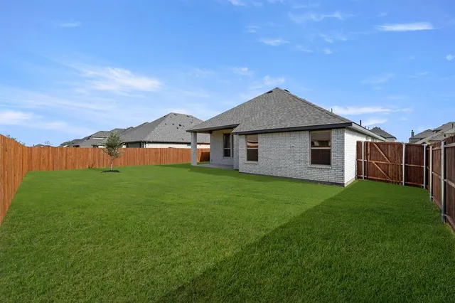 a backyard of a house with lots of green space