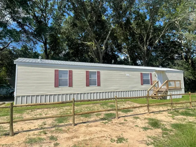 a view of a house with a backyard