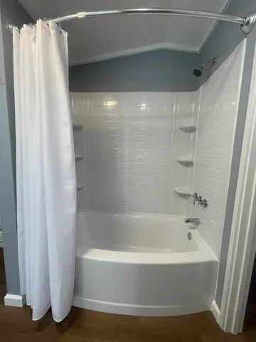 a bathroom with bathtub and shower