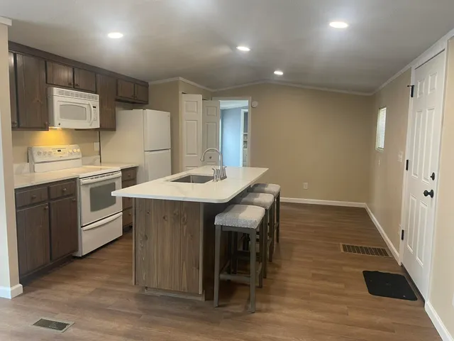 a large kitchen with a table and chairs in it