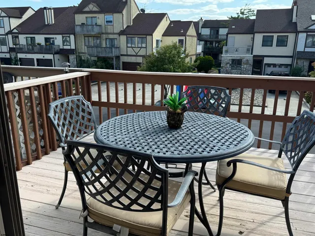 a view of a chairs and table on the deck