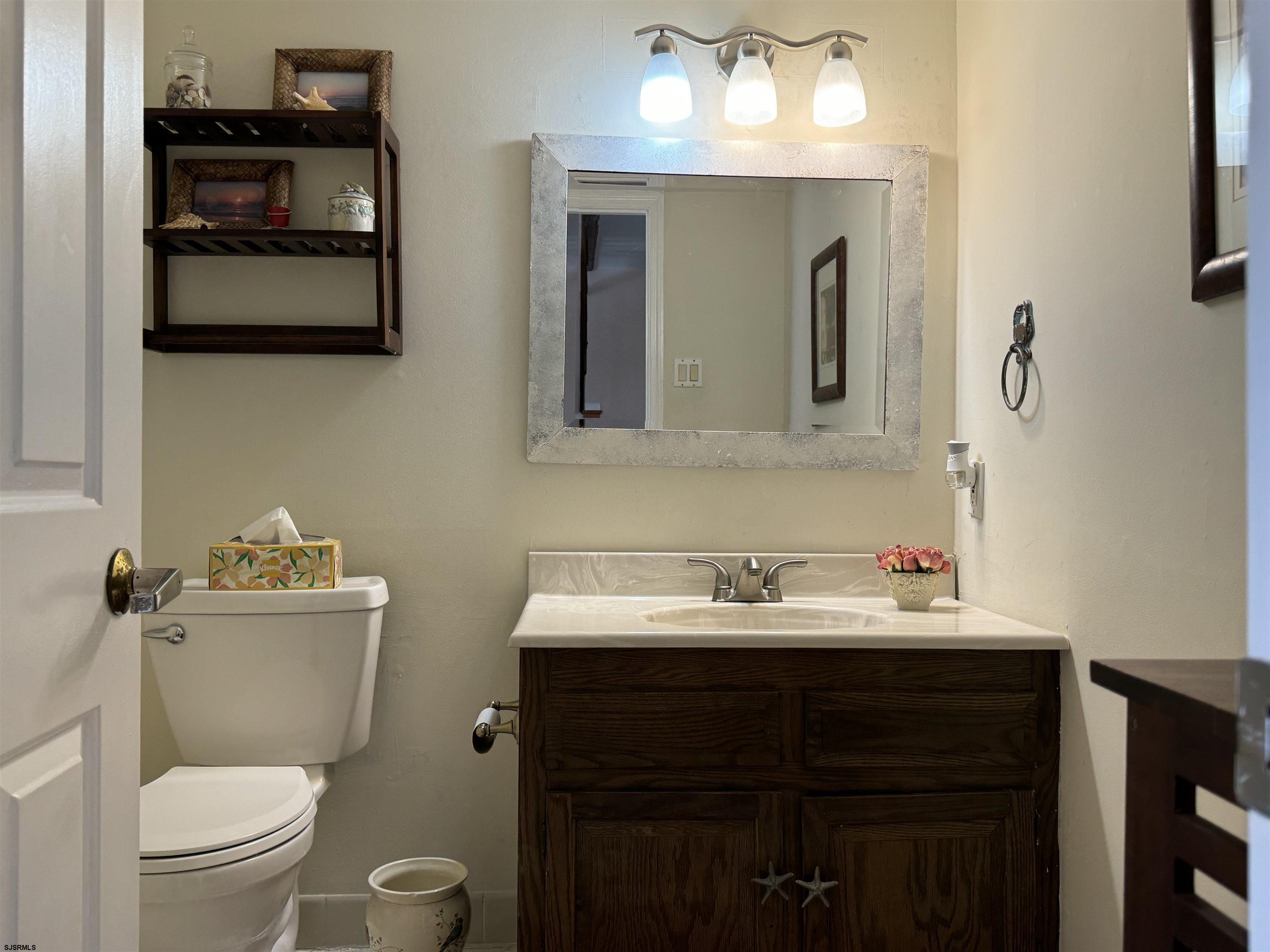 25 Beacon Lane Brigantine, NJ 08203 - Photo 19 of 36 a bathroom with a toilet sink and mirror