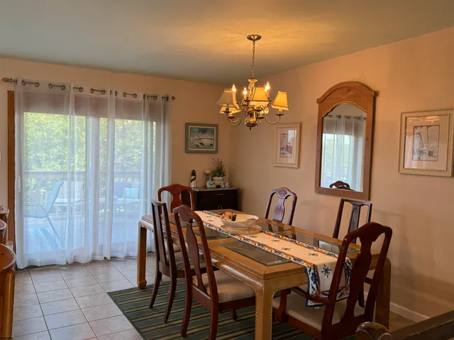 a view of a dining room with furniture and chandelier