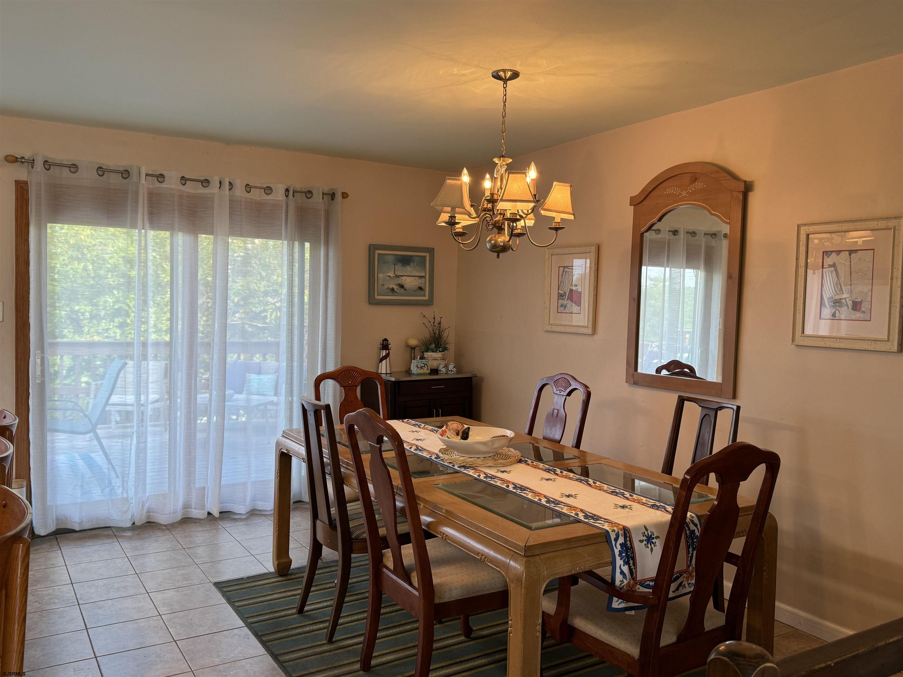 25 Beacon Lane Brigantine, NJ 08203 - Photo 23 of 36 a view of a dining room with furniture and chandelier