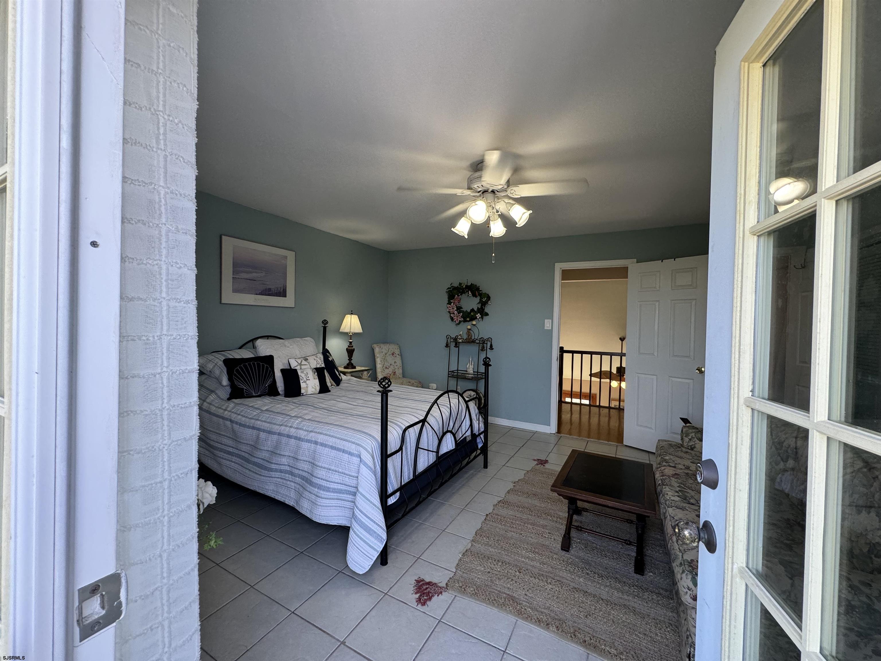 25 Beacon Lane Brigantine, NJ 08203 - Photo 29 of 36 a bedroom with a bed a chandelier and dresser