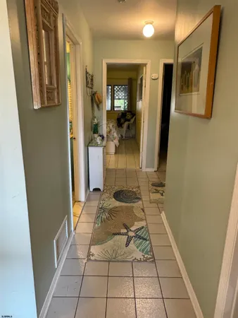 a hallway with a white stove top oven and bathroom