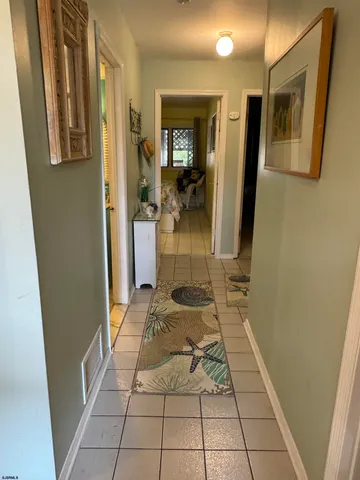 a hallway with a white stove top oven and bathroom