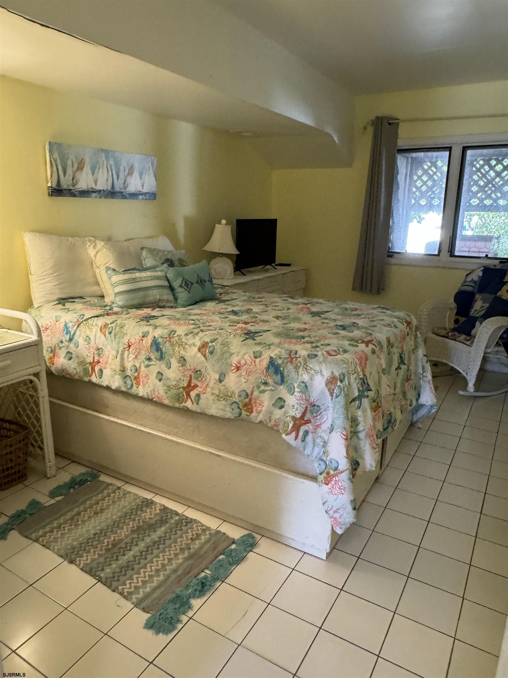 25 Beacon Lane Brigantine, NJ 08203 - Photo 5 of 36 a bedroom with a bed and window