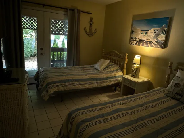 a bedroom with a bed and a painting on the wall