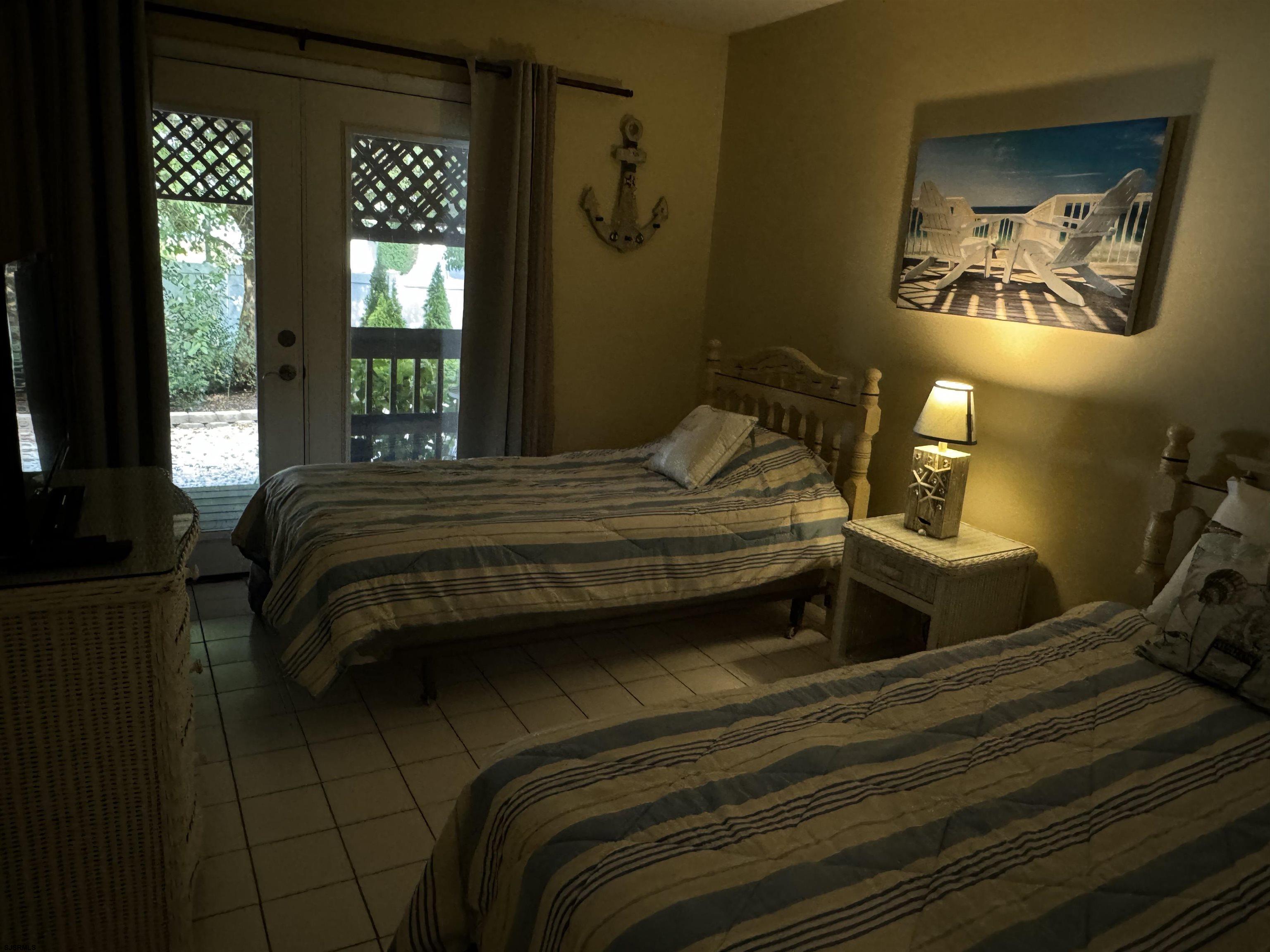 25 Beacon Lane Brigantine, NJ 08203 - Photo 6 of 36 a bedroom with a bed and a painting on the wall