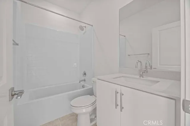 a white toilet sitting next to a bathroom sink