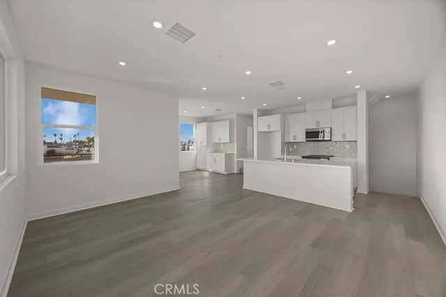 a view of kitchen with kitchen island and stainless steel appliances