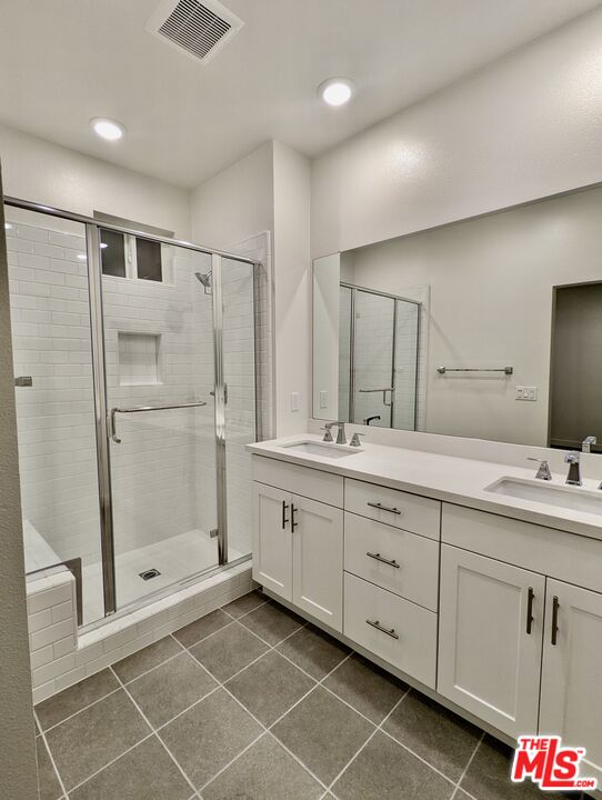 7107 Ryder Ln. Gardena, CA 90248 - Photo 6 of 11 a spacious bathroom with a shower sink and mirror