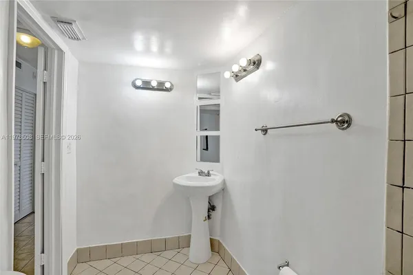 a bathroom with a sink a mirror and shower