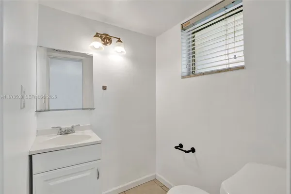 a bathroom with a sink toilet and vanity