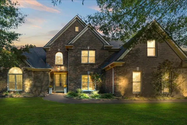 a front view of a house with a yard