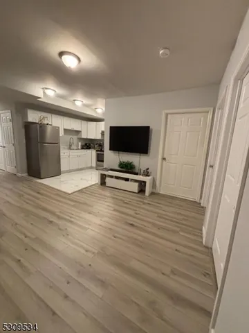 a view of a livingroom with kitchen and furniture