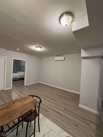 a view of room with furniture and wooden floor