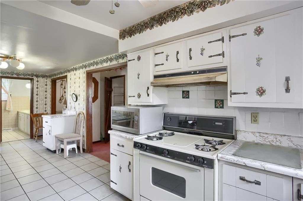 401 West Jefferson Road Butler, PA 16002 - Photo 11 of 22 a kitchen with cabinets and stove top oven