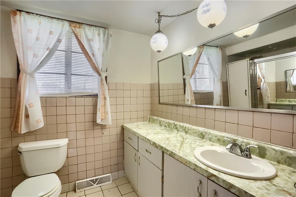 401 West Jefferson Road Butler, PA 16002 - Photo 16 of 22 a bathroom with a toilet sink vanity and mirror