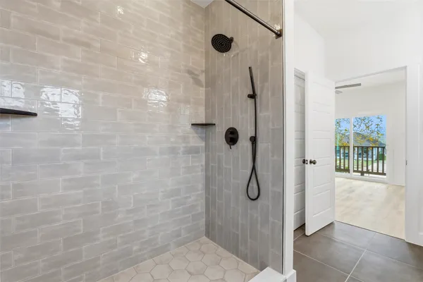 an empty room with a window and a ceiling fan