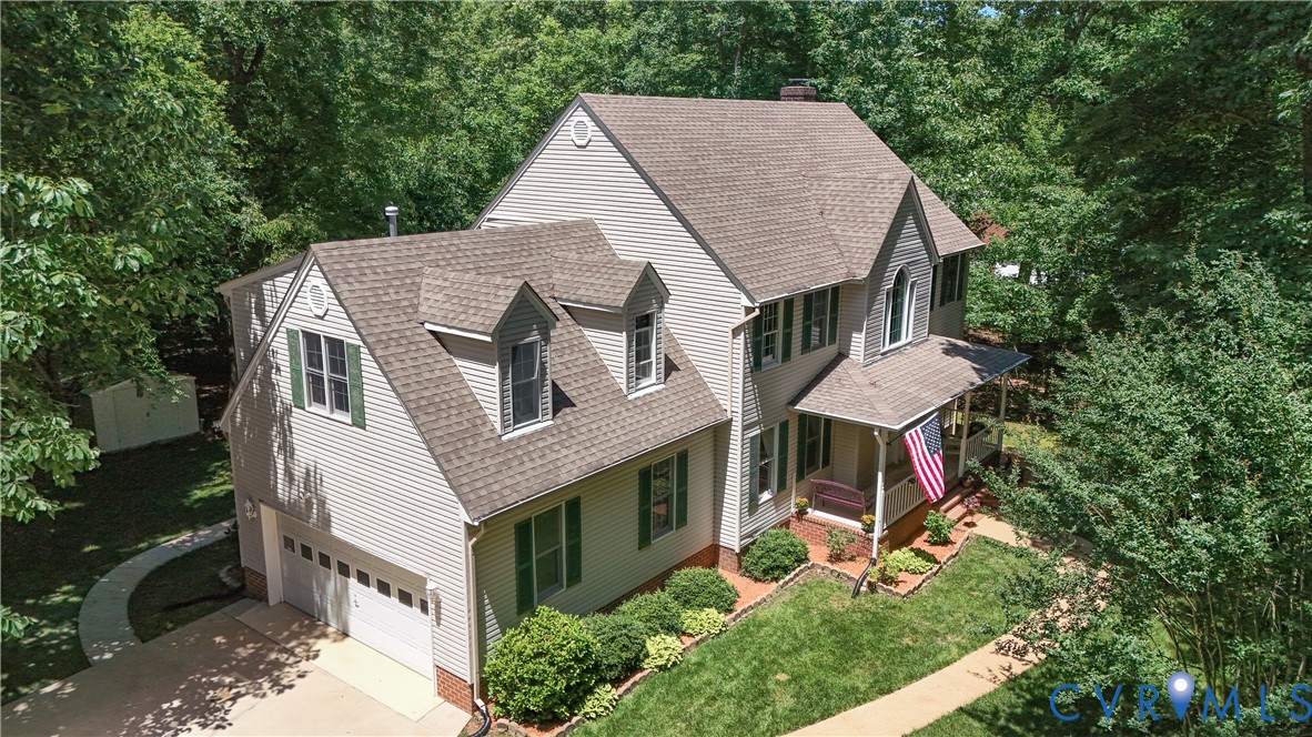12512 2nd Branch Road Chesterfield, VA 23838 - Photo 46 of 56 a aerial view of a house with table and chairs under an umbrella