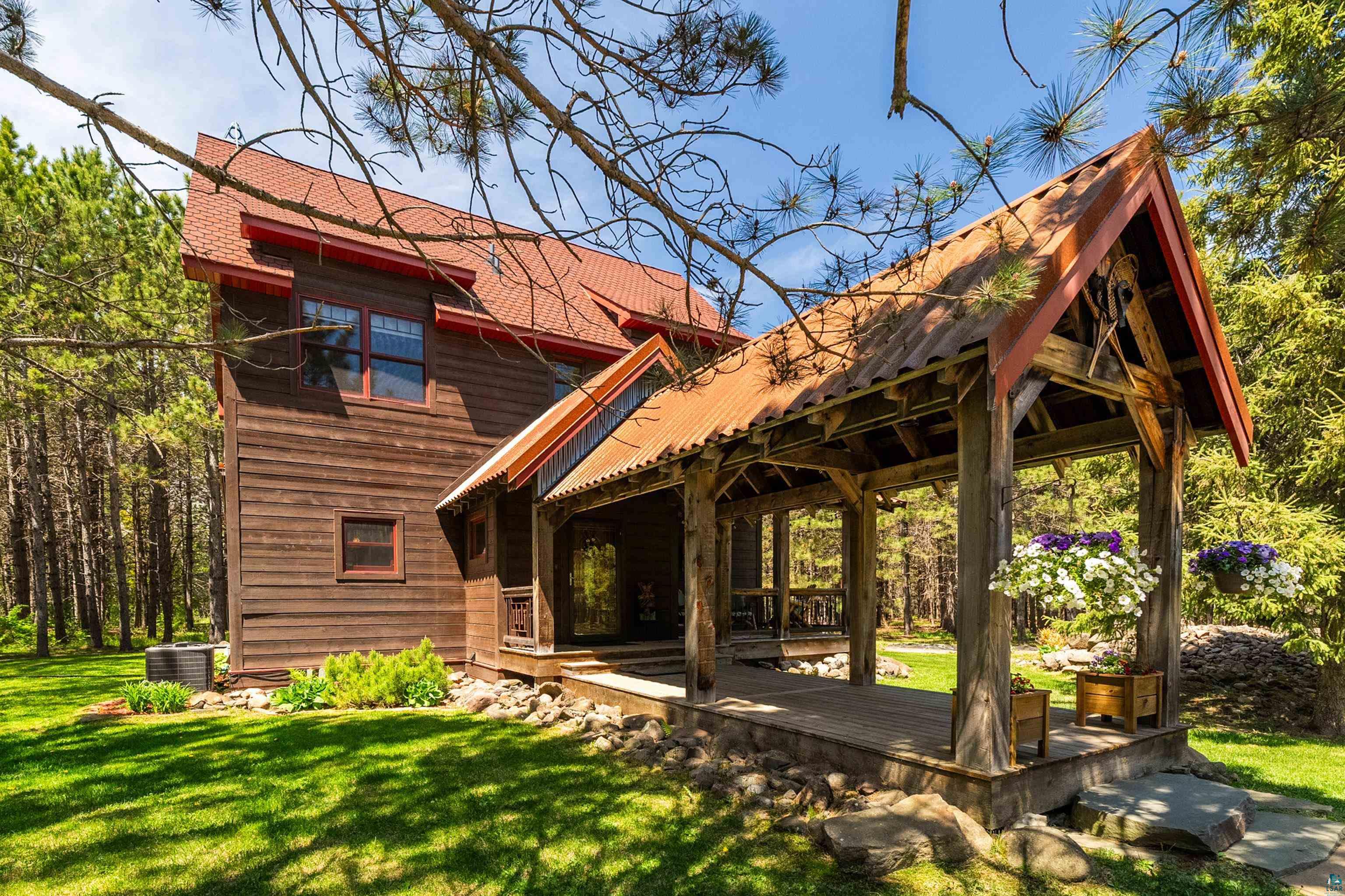 75 East Stark Road Esko, MN 55733 - Photo 56 of 87 Wood-sided residential structure featuring a prominent covered porch with a metal roof