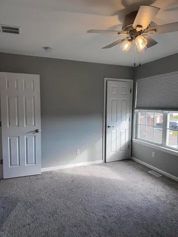 a front view of a house with a yard table and chairs
