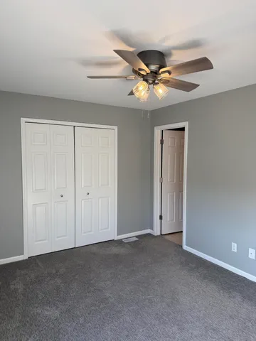 a view of a swimming pool with a patio and a yard