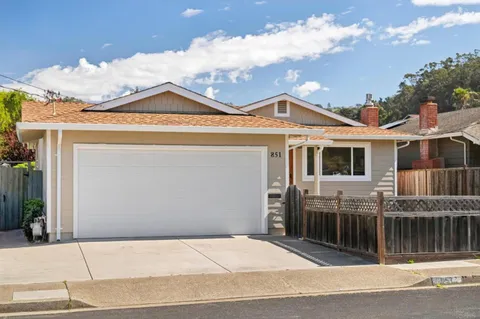 a view of a house with a wooden fence