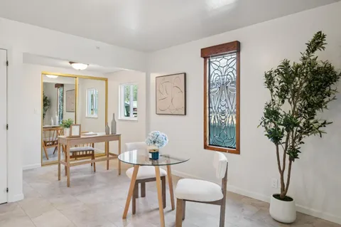 a dining room with furniture and wooden floor