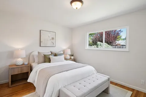 a bedroom with a bed and a lamp