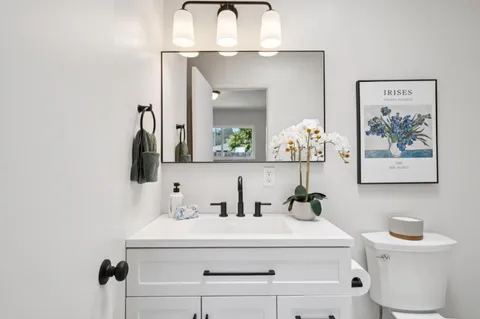a bathroom with a sink vanity and mirror