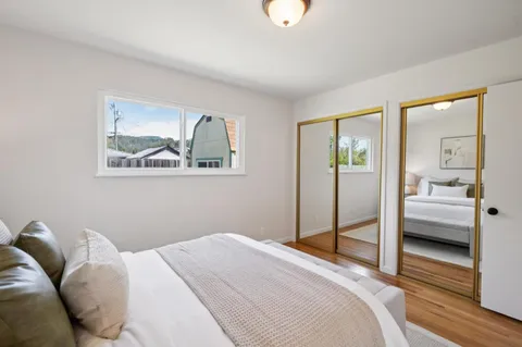 a bedroom with a bed and glass door