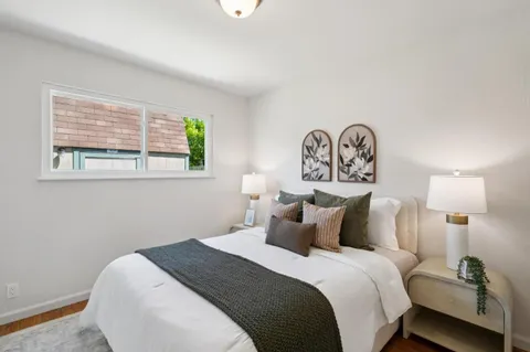 a bedroom with a bed and a lamp