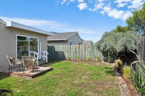 a front view of a house with a yard table and chairs