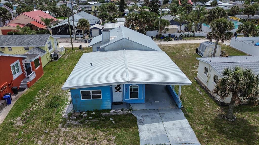 a aerial view of a house next to a yard